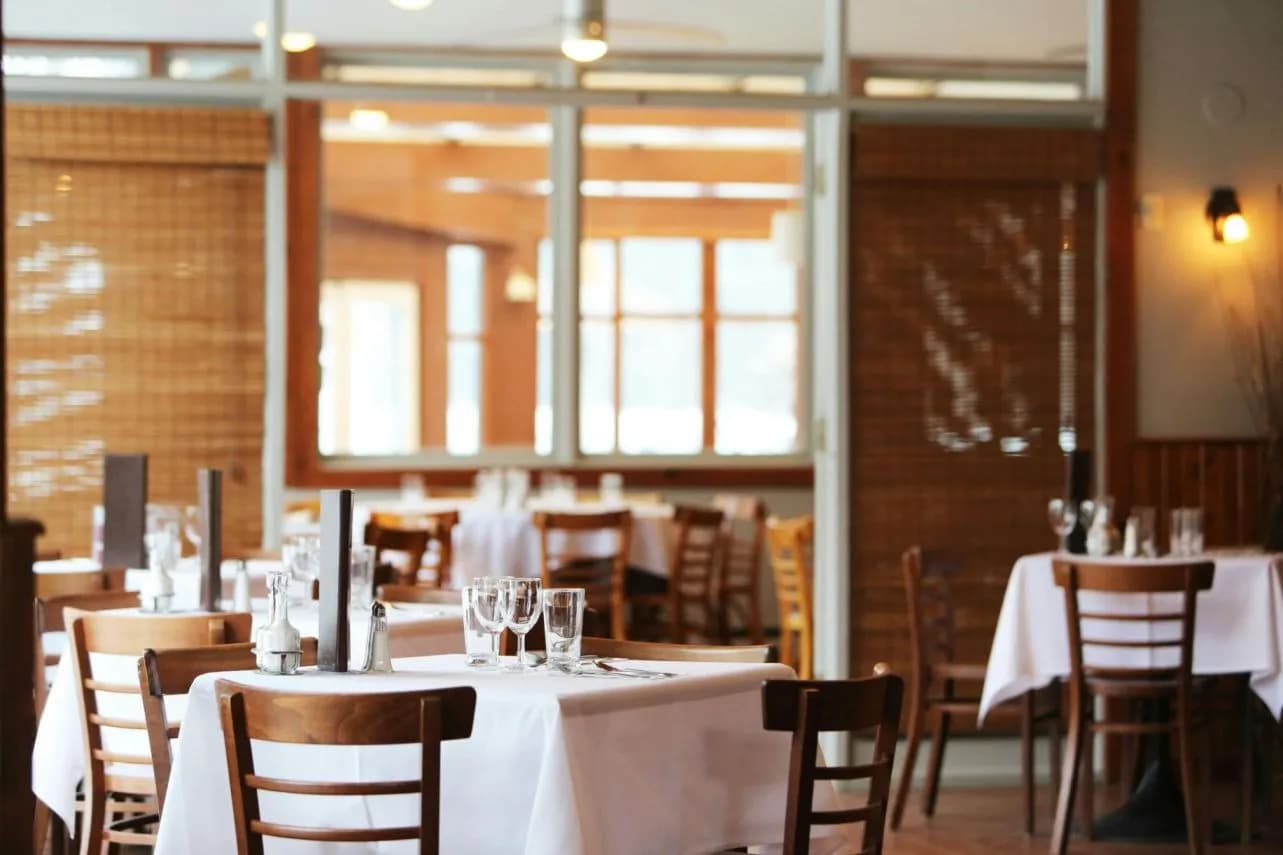 An empty restaurant, set and ready for service.